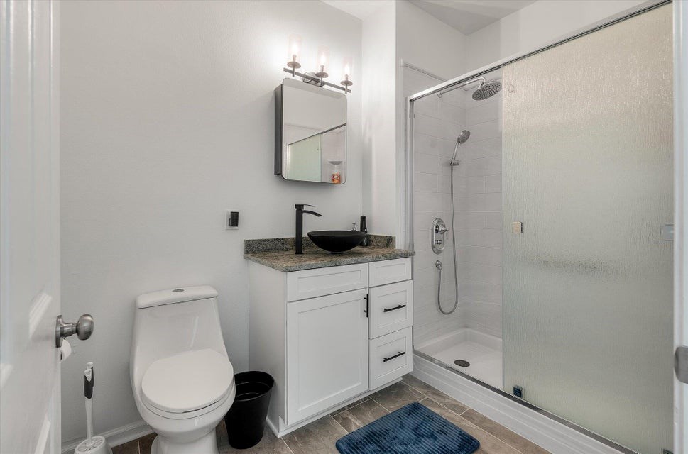 primary bath updated toilet, vanity and walk-in shower.